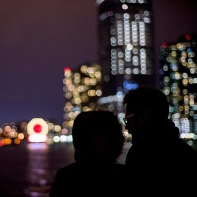 Nighttime City Lights Sail Aboard a Classic Sailboat
