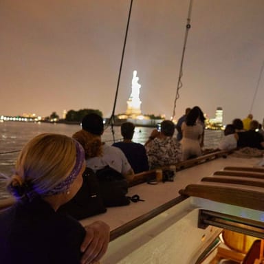 Nighttime City Lights Sail Aboard a Classic Sailboat