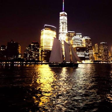 Nighttime City Lights Sail Aboard a Classic Sailboat